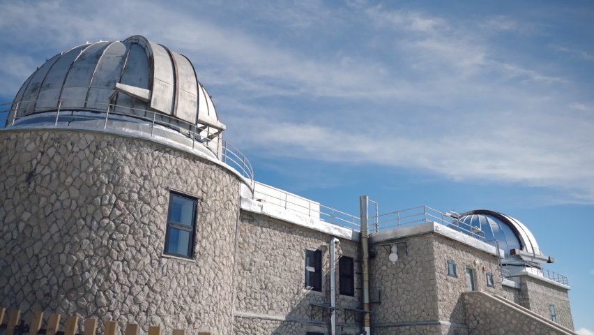 Observatory building with dome for outer space researching, observatory station located at the foot of the mountain hill transmitting important information data, observatory telescope exploring space