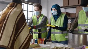 Muslim volunteers came together to arrange hot meals for the homeless and those in need. Charity iftar at the mosque in the month of Ramadan - Powered by Shutterstock - Get 15% off with code: PIKWIZARD15