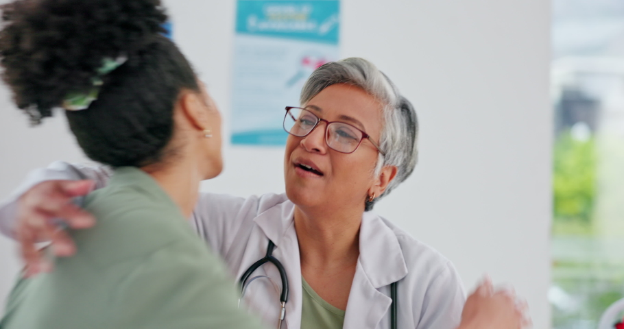Doctor, patient and hug for healthcare appointment, consultation or checkup at the hospital. Elderly medical professional hugging female in care, support and thank you after diagnosis at the clinic Royalty-Free Stock Footage #1097726365