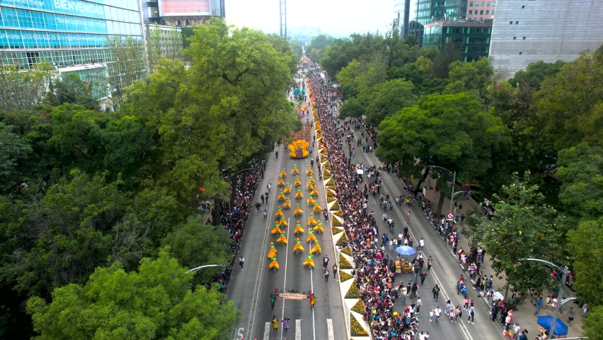 overhead drone shot of the day of the dead parade in mexico city with people in costumes Royalty-Free Stock Footage #1097728443