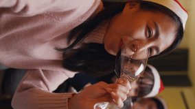 Close-up group of Asia colleague gathering New year holidays party together. Happy friend look at camera phone video call online christmas thanksgiving dinner at home. Vertical Screen. - Powered by Shutterstock - Get 15% off with code: PIKWIZARD15