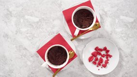 Time lapse. Flat lay. Step by step. Chocolate mug cakes garnished with whipped cream and chocolate hearts and lips.