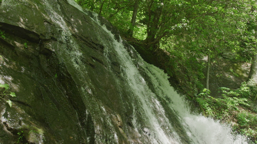 Close up of water cascading over rock powerful waterfall in North Carolina in Great Smoky Mountain National Park