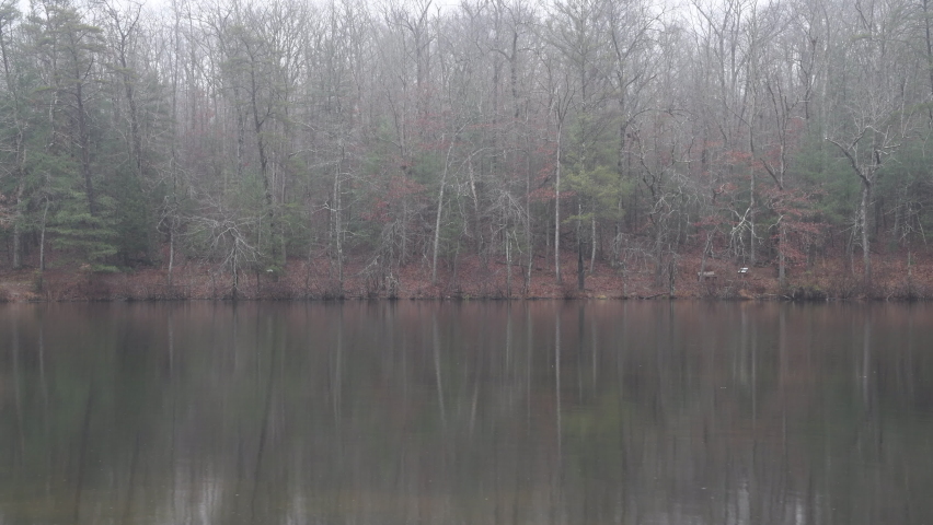 Byrd Creek lake in Cumberland Mountain is very peacefully calm as raindrops bounce off the glassy surface. Royalty-Free Stock Footage #1097769227