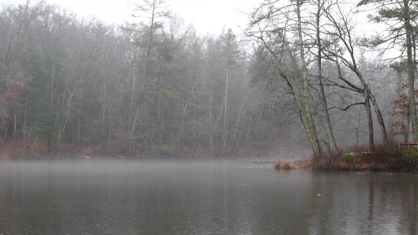Byrd Creek lake in Cumberland Mountain is very peacefully calm as raindrops bounce off the glassy surface. Royalty-Free Stock Footage #1097769241