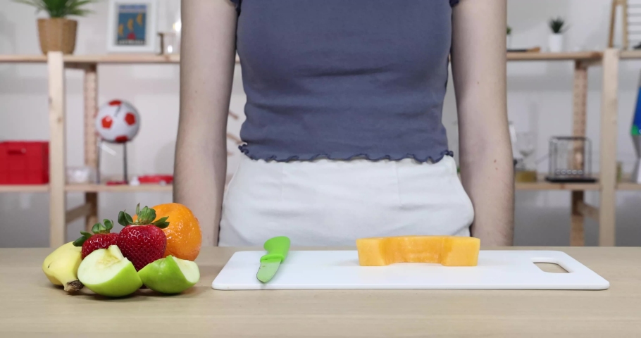 Demonstrating physical change in science by cutting fruit to make a fruit salad. Royalty-Free Stock Footage #1097778165