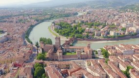Inscription on video. Verona, Italy. Flying over the historic city center. Castelvecchio Castello Scaligero, summer. Lightning strikes the letters, Aerial View, Point of interest