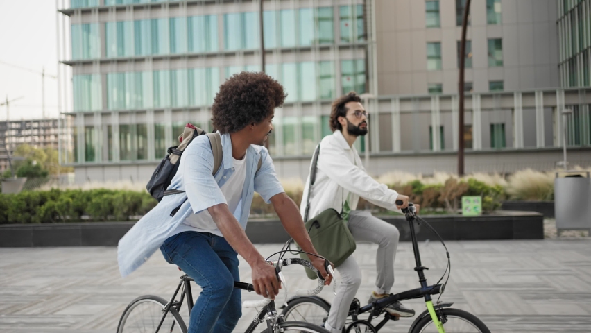 Happy casual business friends going to work with bicycle in the city  Royalty-Free Stock Footage #1097779749