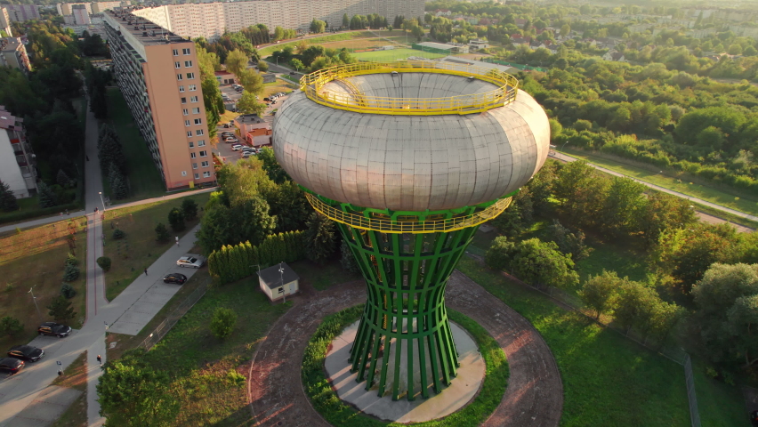 Water tower in Tarnow, in Malopolskie voivodeship, Poland. Aerial view of the water pressure tank called bania in residential district of Tarnow. Unusual urban modernist architecture building. 