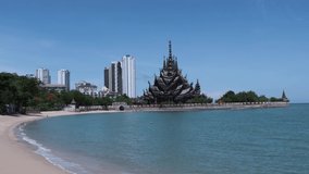 Sanctuary of Truth wood Temple on sea beach in Pattaya Thailand beautiful landscape under blue cloudy sky