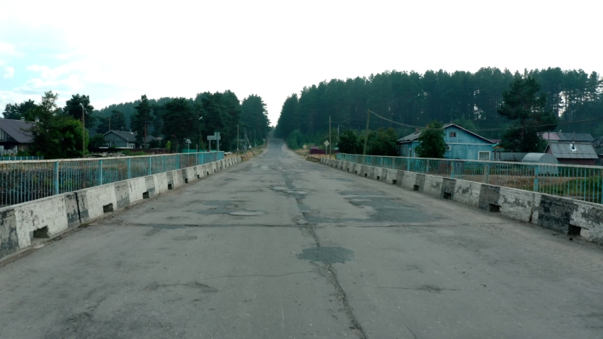 Bad car road. Awful condition of highway with pits, portholes, old damaged asphalt with holes, cracks, portholes from drone copter flying