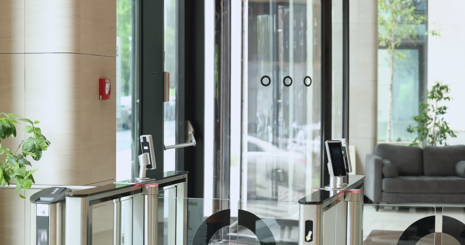 Businesspeople in formal wear going at lunch break, using electronic card reader, leaving modern corporate office building area passing through automatic security turnstiles gateway. Working day ended Royalty-Free Stock Footage #1097784997