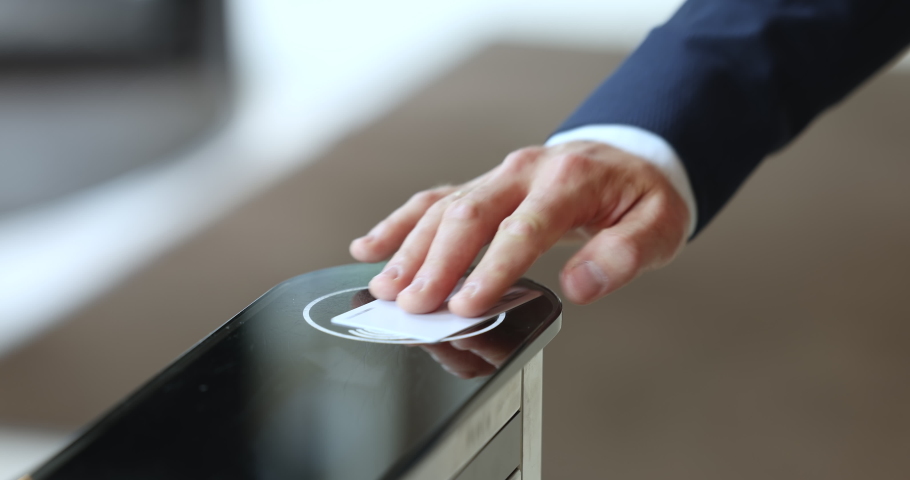 Unrecognizable man arm using pass card, swipe to electronic reader, passing security system checkpoint, opens automatic gates, enters or leaves office area before or after working day, close up view | Shutterstock HD Video #1097785109