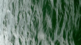 Calm sea wave with ripples running in Black sea. Sun reflection. Natural marine background. Vertical format.