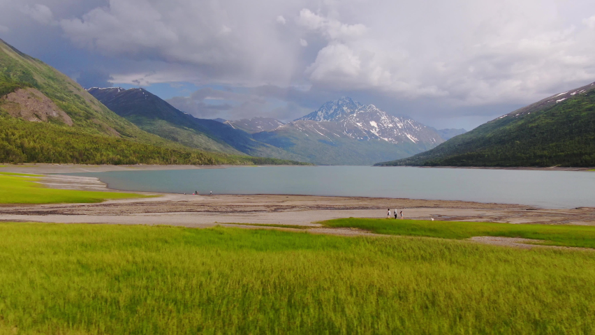 Alaska Lakeside Landscape On Cloudy Summer Day, Beautiful Panoramic Aerial View of Wild Nature, Valley Lake With Mountains Around - Sideways Tracking