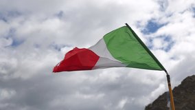 Close up view in slow motion of the Italian flag moved by the wind in the morning. Blurred cloudy sky on the background.  - Powered by Shutterstock - Get 15% off with code: PIKWIZARD15