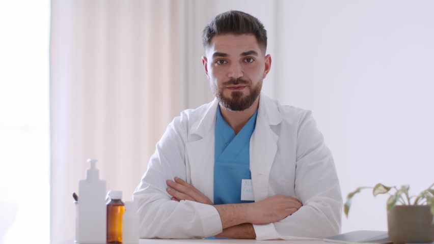 Online medical appointment. Camera pov portrait of young professional middle eastern man doctor recording blog, explaining purpose of medication to patient, slow motion, free space Royalty-Free Stock Footage #1097794719