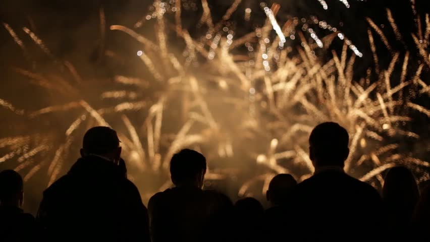 Silhouettes of people watching fireworks