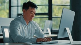Mature Asian businessman chinese korean office worker specialist male work on computer develop project online look at camera confident smile. Portrait successful senior man business profession concept - Powered by Shutterstock - Get 15% off with code: PIKWIZARD15