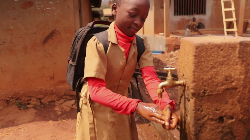 A student drinks water from a public fountain in africa, a concept of drought and water scarcity in africa.	 Royalty-Free Stock Footage #1097804855