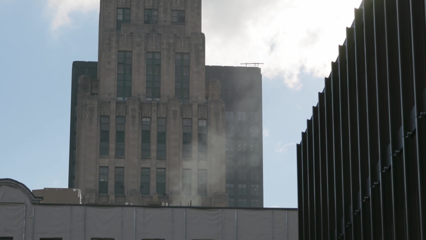 Smoke Rising From Building Chimney In Montreal, Quebec. Residential Tower In Background. medium shot