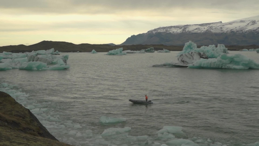 rescuer lifeguard on a boat in Jökulsárlón glacier lagoon with icebergs