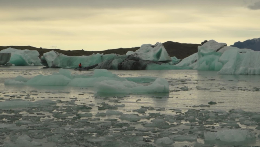 rescuer lifeguard on a boat in Jökulsárlón glacier lagoon with icebergs