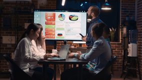 Company employee presenting analytics research in business meeting, showing statistics on digital board. Marketing revenue report presentation, diverse team planning sales strategy. Tripod shot. - Powered by Shutterstock - Get 15% off with code: PIKWIZARD15