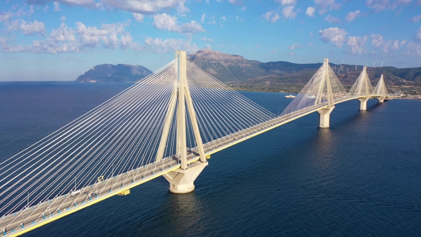 Aerial drone video of famous state of the art modern cable strait bridge of Rio Antirio crossing corinthian gulf from Peloponnese seaside city of Rio to Antirio - mainland Greece Royalty-Free Stock Footage #1097815051
