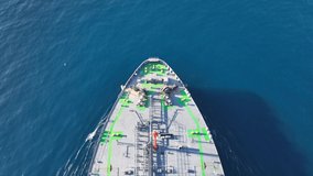 Aerial drone video of huge crude oil tanker cruising in open ocean deep blue sea