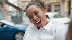 African american woman smiling confident having video call at street