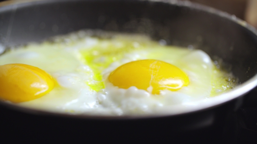 Сooking Fried Eggs For Breakfast Royalty-Free Stock Footage #1097823909