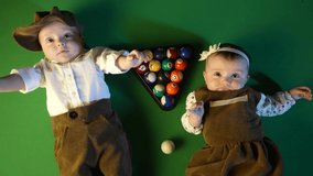 two kids in retro clothes on a billiard pool table. happy family kid dream concept. twin brother and sister billiards lifestyle gangsters - Powered by Shutterstock - Get 15% off with code: PIKWIZARD15