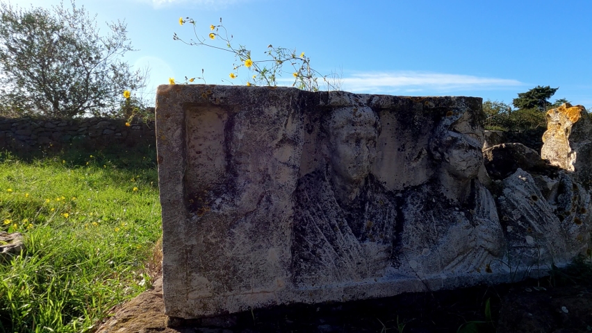 Ancient Roman structures and stone monuments line the roadsides of the Via Appia Antica in Rome Italy