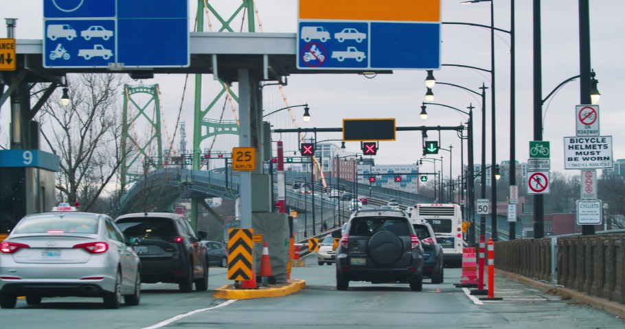 Time lapse of cars entering the toll bridge in Halifax city Canada. Cars cross a toll bridge to get into the down tout of Halifax.
