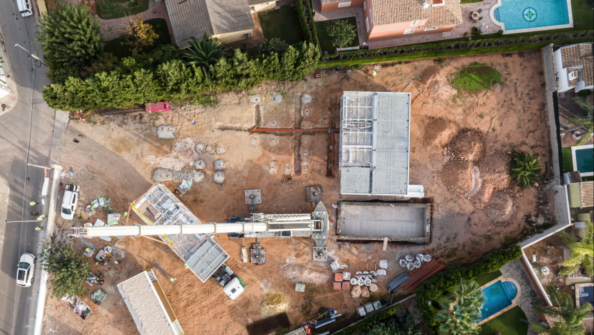 Top down aerial timelapse of construction crane workers assembling modular home Royalty-Free Stock Footage #1097835749