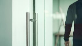 Close up hand of successful businessman open the glass office entrance in the modern business centre Confident employee man walking through the door entering meeting room indoors Business life concept - Powered by Shutterstock - Get 15% off with code: PIKWIZARD15