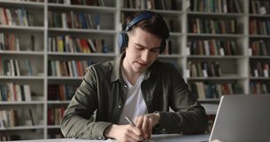 Highschool student in headphones talk to online teacher, take notes studying in library, take part in video call, improve foreign language knowledge using internet. Education, virtual meeting event