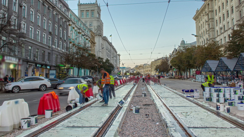 Tram rails at the stage of their integration into concrete plates on the road timelapse. Filling by liquid resin for reduction of vibration and noice. The process of reconstruction of tram tracks in