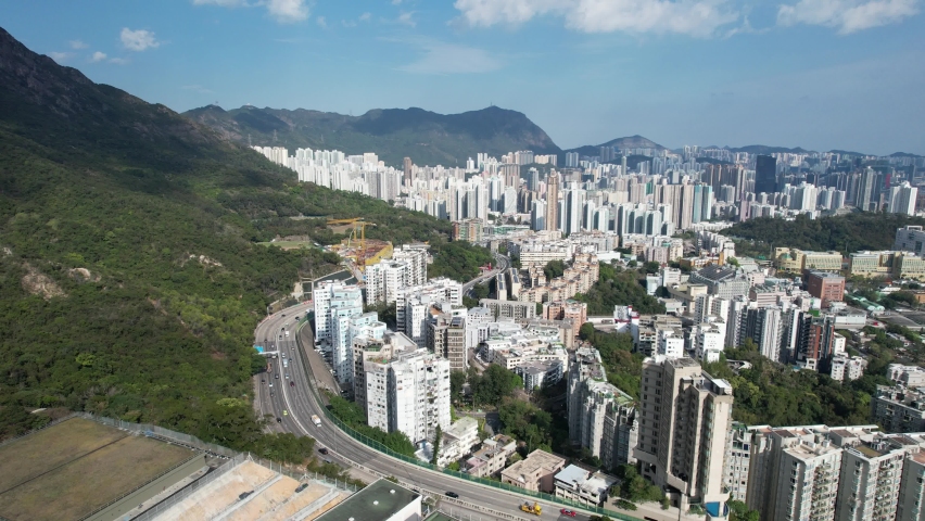 City Skyview in Hong Kong 4K Aerial drone shot of the residential area in Kowloon Tong Peninsula near Lion Rock, Victoria Harbour Financial Central District