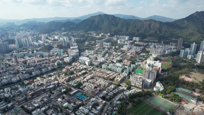City Skyview in Hong Kong 4K Aerial drone shot of the residential area in Kowloon Tong Peninsula near Lion Rock, Victoria Harbour Financial Central District