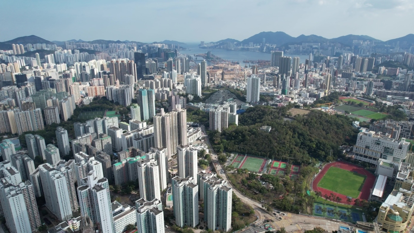 City Skyview in Hong Kong 4K Aerial drone shot of the residential area in Kowloon Tong Peninsula near Lion Rock, Victoria Harbour Financial Central District