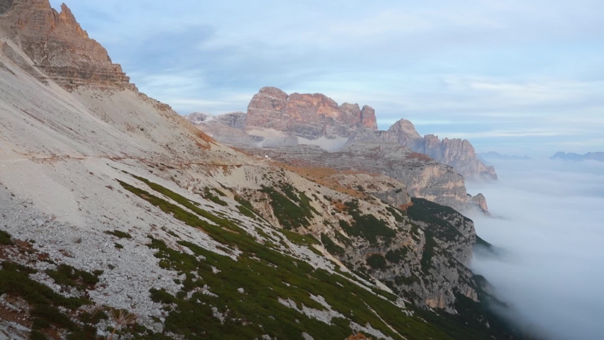 Full HD video (High Definition). Rocky slopes in Tre Cime Di Lavaredo National Park. Thick fog spreads of mountain canyon. Fantastic autumn view of Dolomite Alps, Italy, Europe.