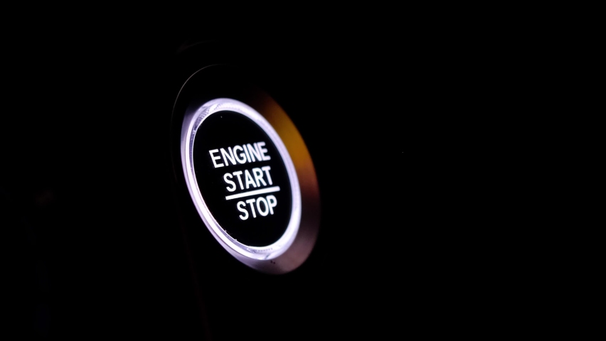 The driver's hand is pressing the car start button. Concept of transportation and technology | Shutterstock HD Video #1097860761