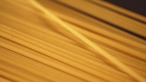 Dry spaghetti close up, macro view of pasta. Yellow food, carb diet, Italian cooking. Authentic Italian spaghetti