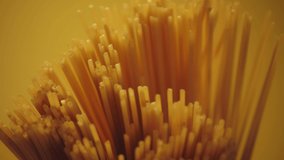 Dry spaghetti close up, macro view of pasta. Yellow food, carb diet, Italian cooking. Authentic Italian spaghetti