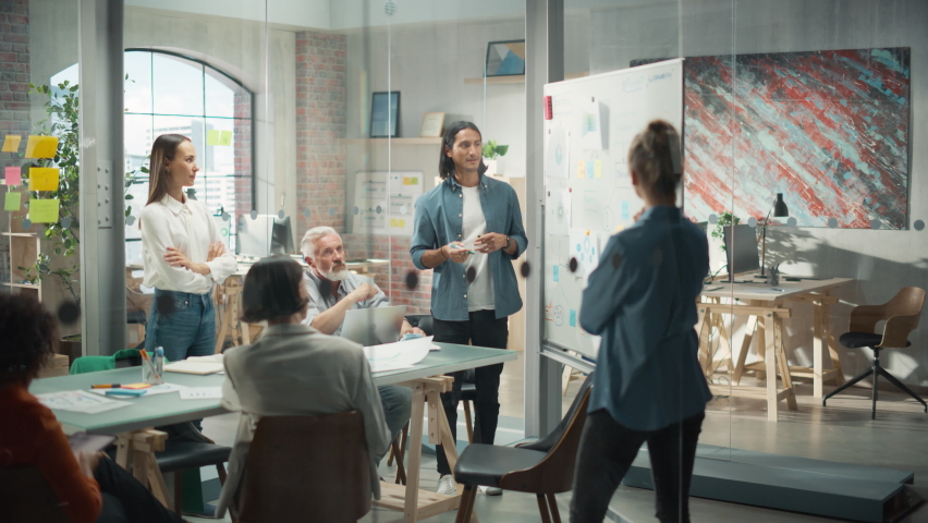 Multiethnic Business Team Discussing Strategy in a Meeting Room at the Office. Latin Male Designer Brainstorming with Heads of Departments and Deciding on a Marketing campaign for New Product Launch Royalty-Free Stock Footage #1097866409
