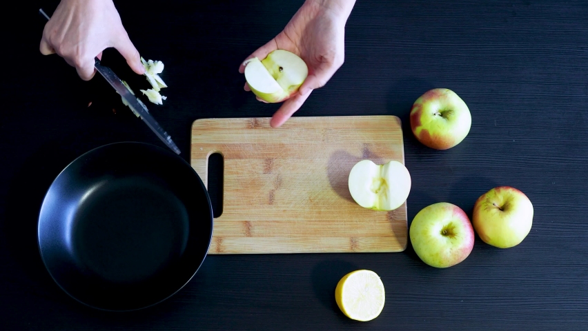 The process of making dessert with apples , homemade cakes . Cut apples into slices, filling for buns