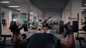 Black man lying on bench and doing dumbbell press exercise while working out in gym.Athete workout training chest with dumbbell bench press pushing up.Bodybuilding Fitness concept. High quality 4k - Powered by Shutterstock - Get 15% off with code: PIKWIZARD15