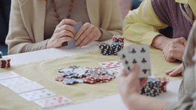 Excited senior woman winning poker game and laughing, her friends disappointed - Powered by Shutterstock - Get 15% off with code: PIKWIZARD15